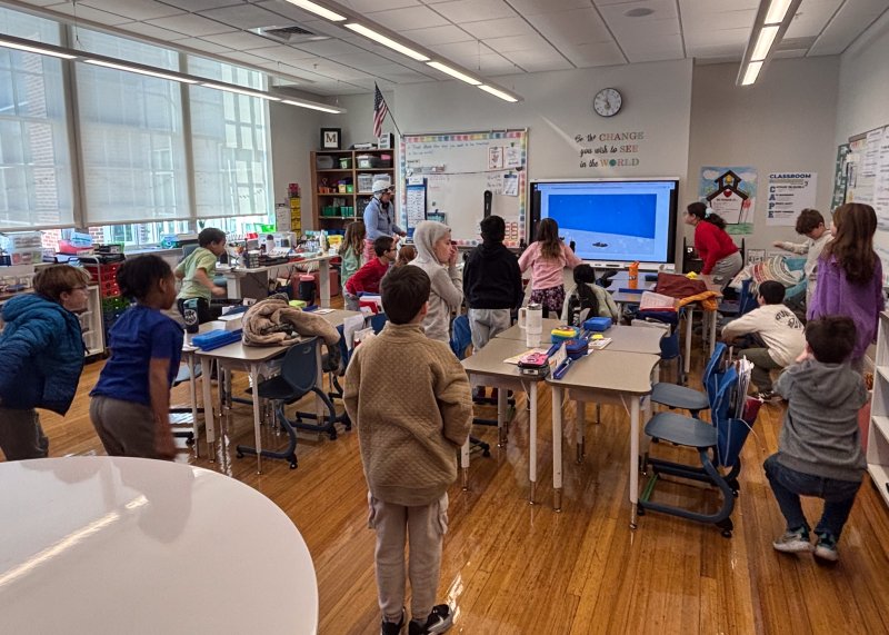 Teacher Leslie Mitchell shares information about her sport, downhill skiing.